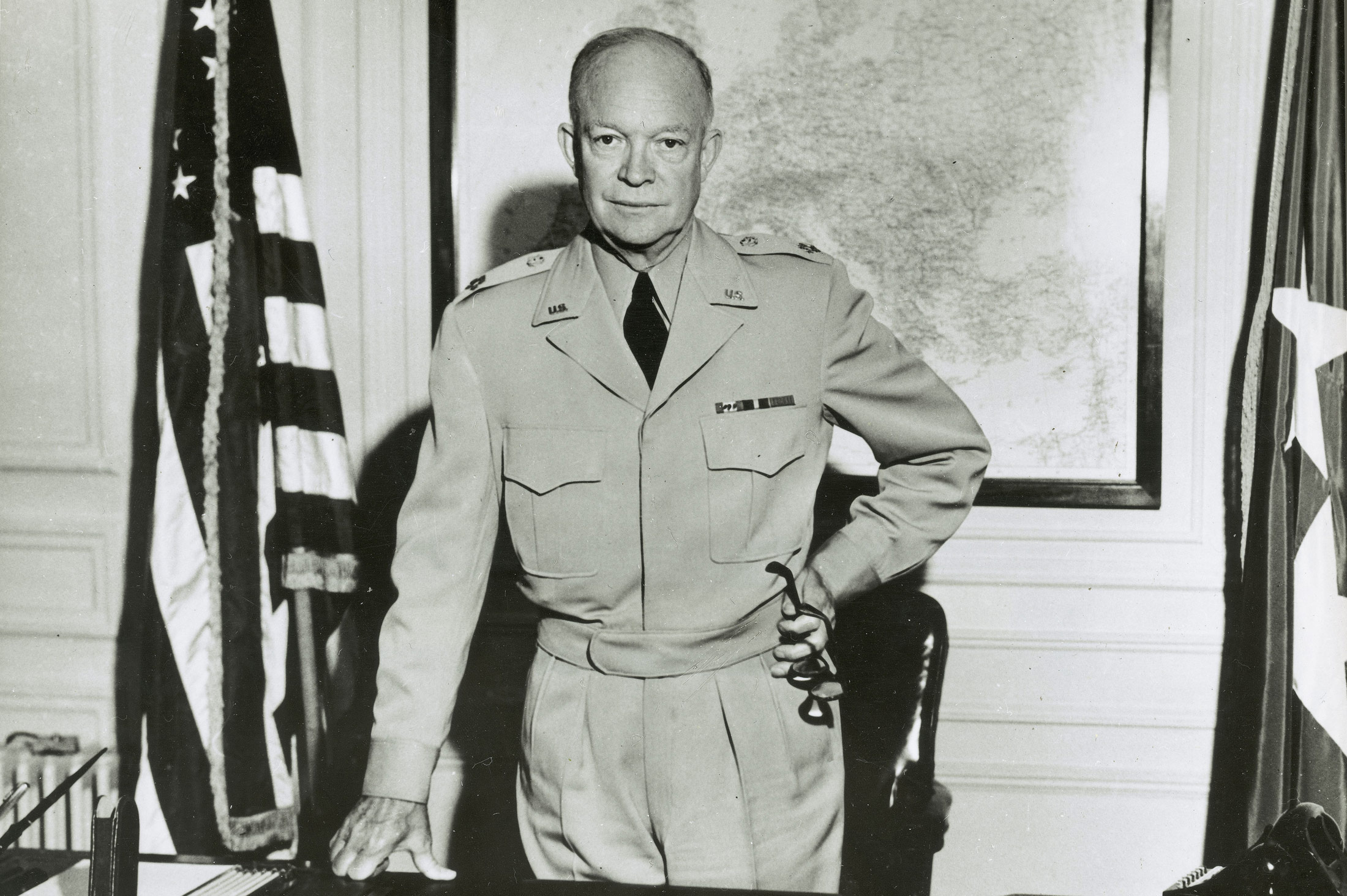 General Eisenhower standing at desk at NATO headquarters