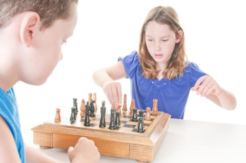 boy and girl playing chess