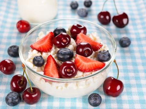 bowl of cottage cheese topped with berries and cherries