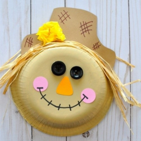 a scarecrow face made out of a paper bowl and paper supplies