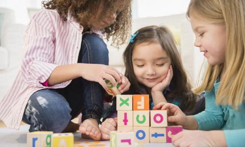 Three children playing with blocks