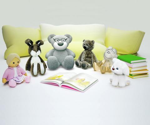 Teddy bears sitting around an open book