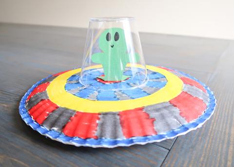 paper plate ufo with a plastic cup and alien inside