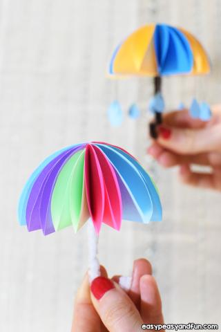 paper umbrella diy craft - folded paper with raindrop cutouts