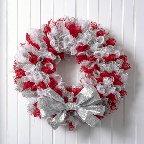 Christmas wreath made with red and white mesh and a silver bow