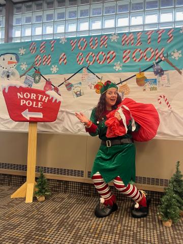 a library staff member dressed as an elf