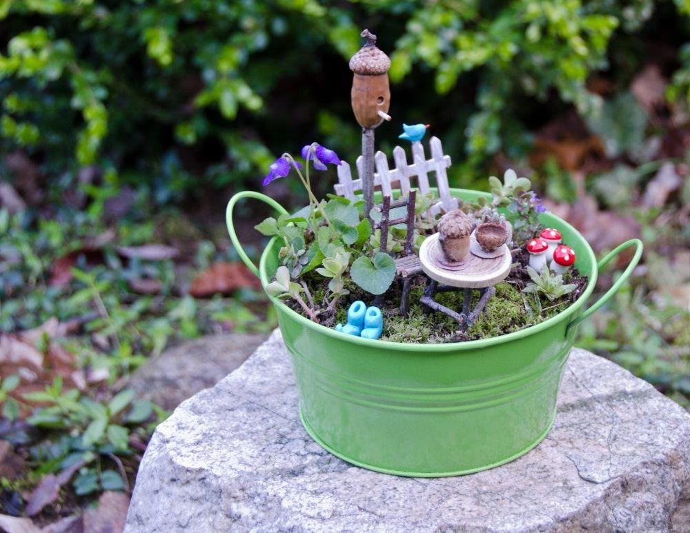 fairy garden in large, green, metal bucket