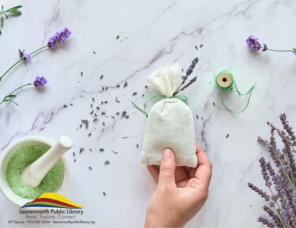 hand making a sachet from lavendar plant