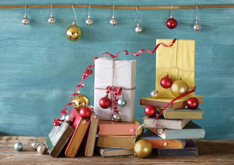 pile of books with Christmas wrappings and decorations