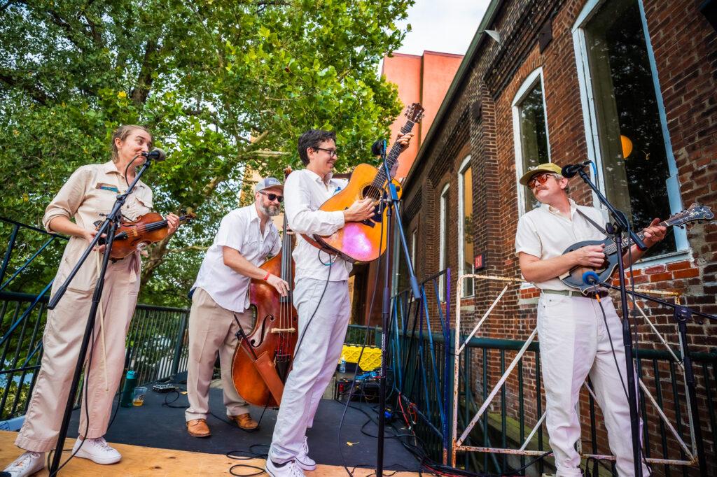 photo of the band on a stage with their instruments