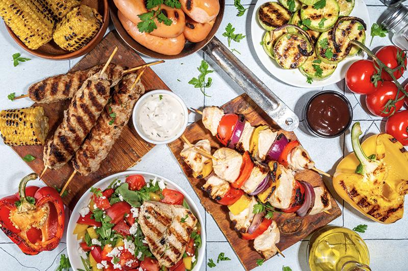 plates of grilled food on summer table