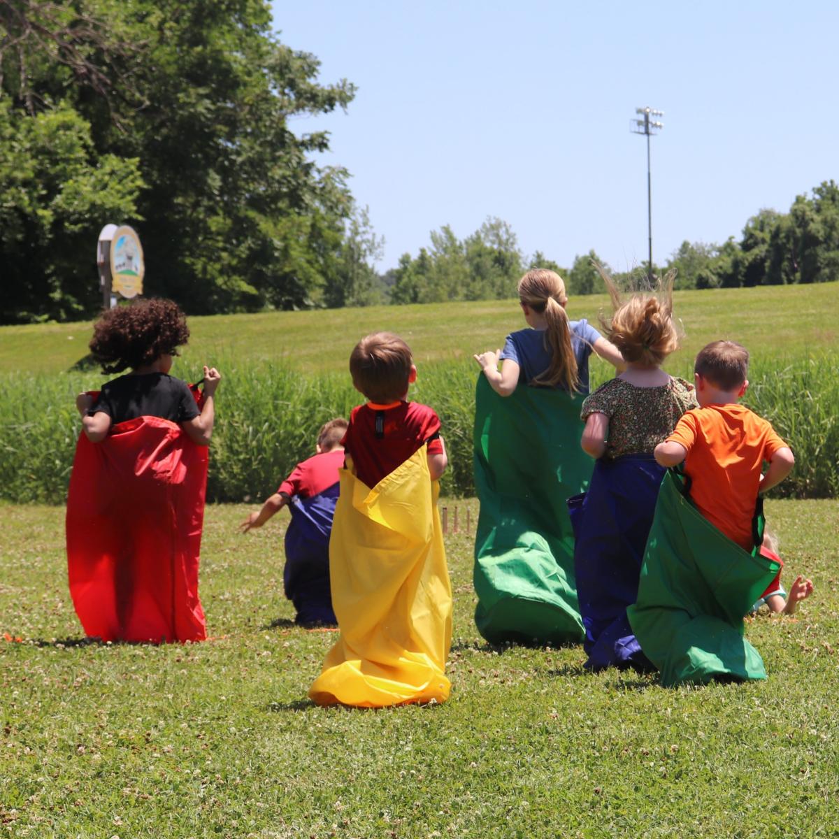 children competing in a potato sack race