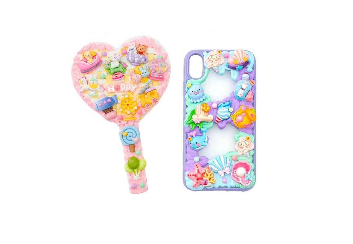 hand mirror and phone case decorated with brightly colored charms and bling