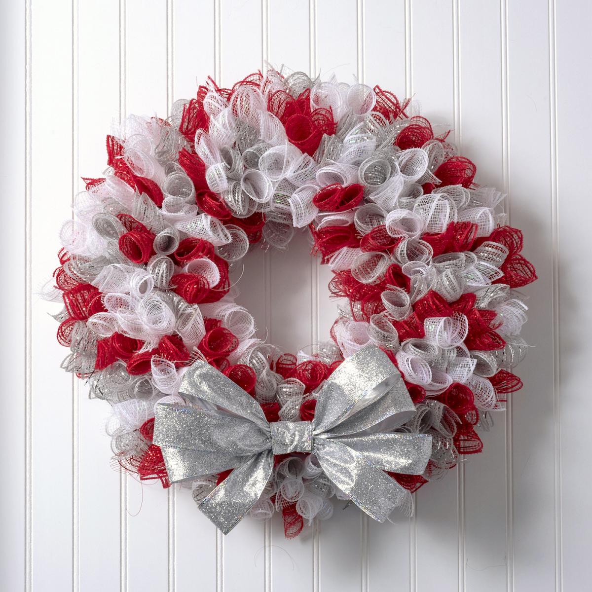 Christmas wreath made with red and white mesh and a silver bow