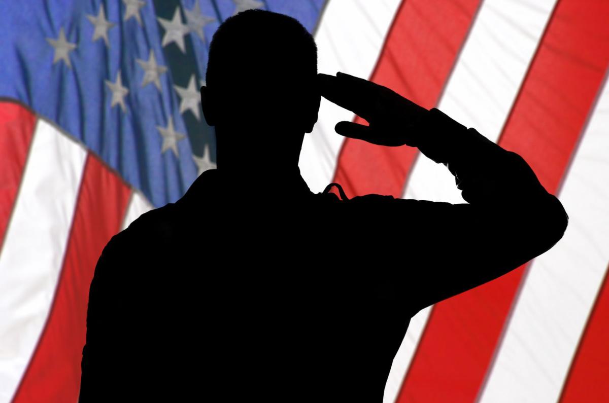 silhouette of soldier saluting the American flag